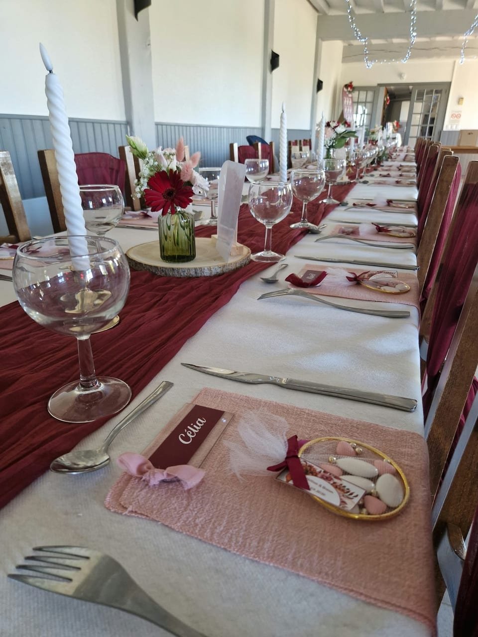 Longue tablée en bordeaux et rose poudré, bougies torsadées et dragées